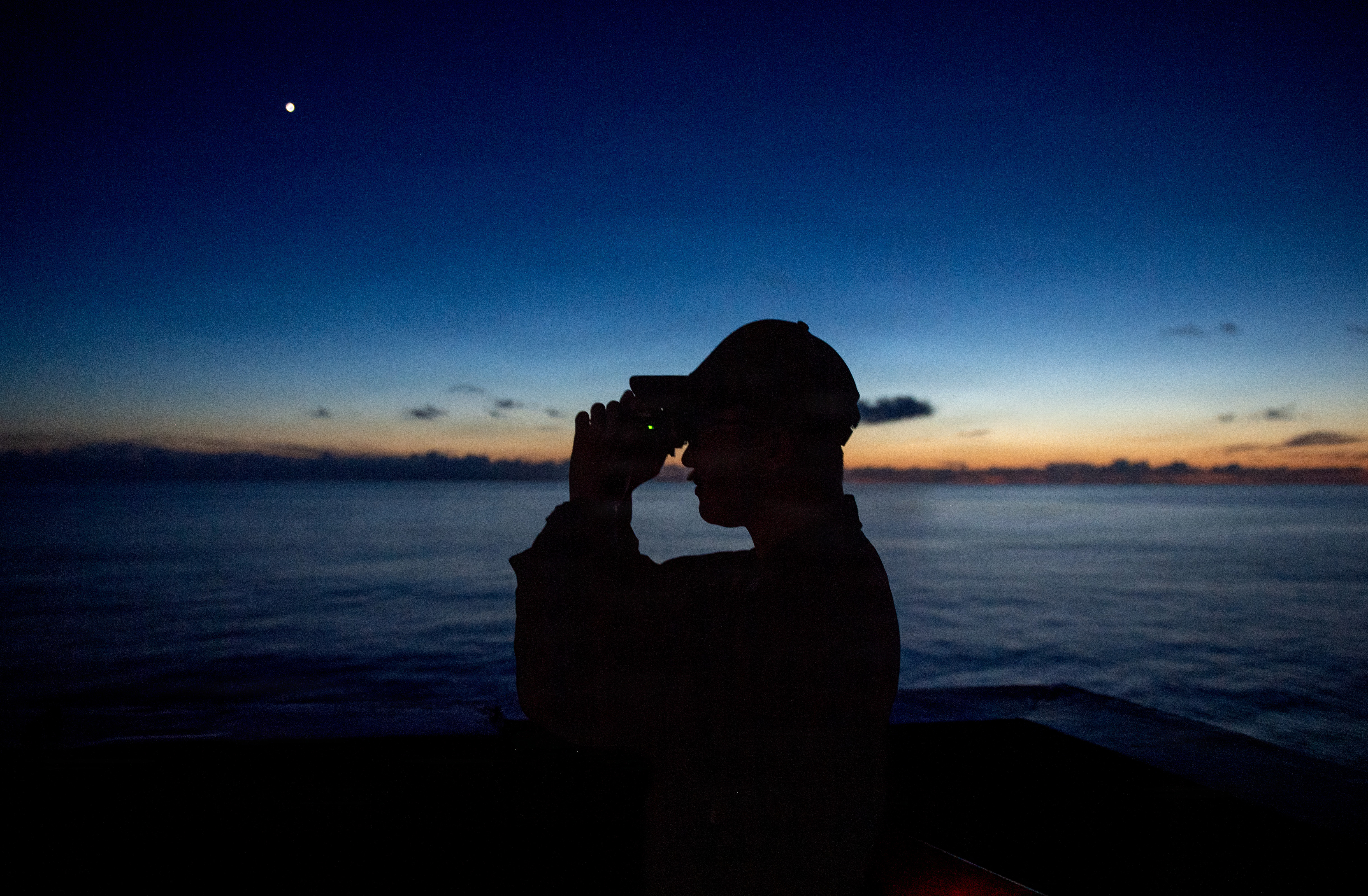 U.S. Navy Intelligence Specialist 1st Class Marc Delcernalupo, assigned to USS San Diego (LPD 22), stands lookout while transiting the East China Sea, July 26, 2026.